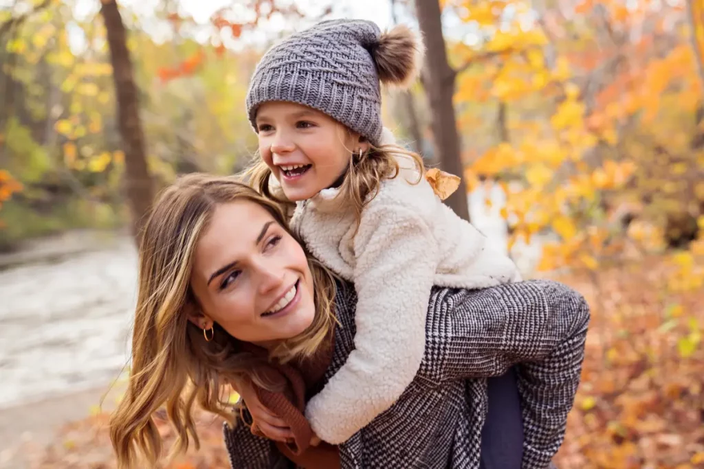 Kleines Mädchen und ihre Mutter im Herbst in einem Park